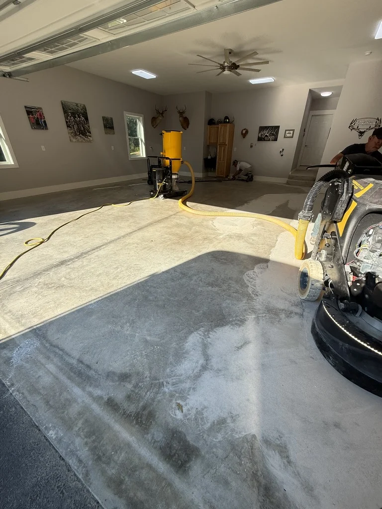 Concrete floor preparation with a floor grinder and dust-extraction equipment in the White Sulphur Springs garage