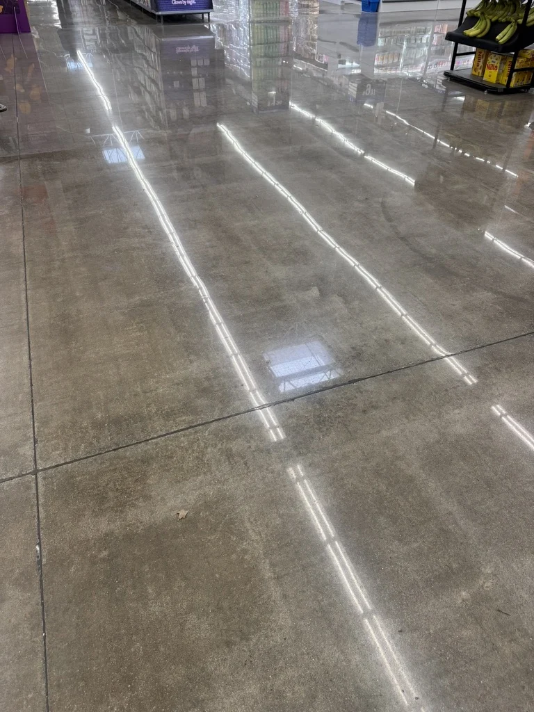 Polished concrete sales floor with control joints beside a produce display