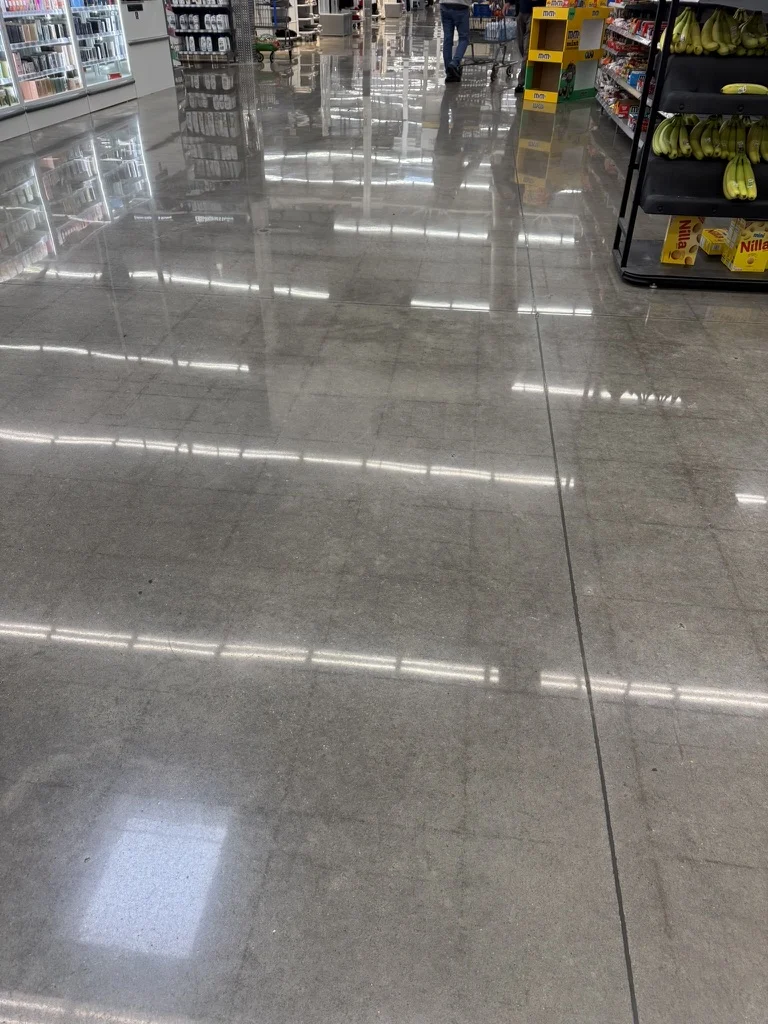 Wide view of the restored polished concrete floor between grocery aisles