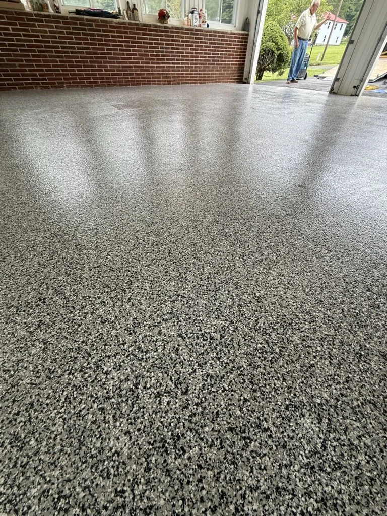 Finished floor — Domino flake texture and sheen near the garage entrance in Wytheville.