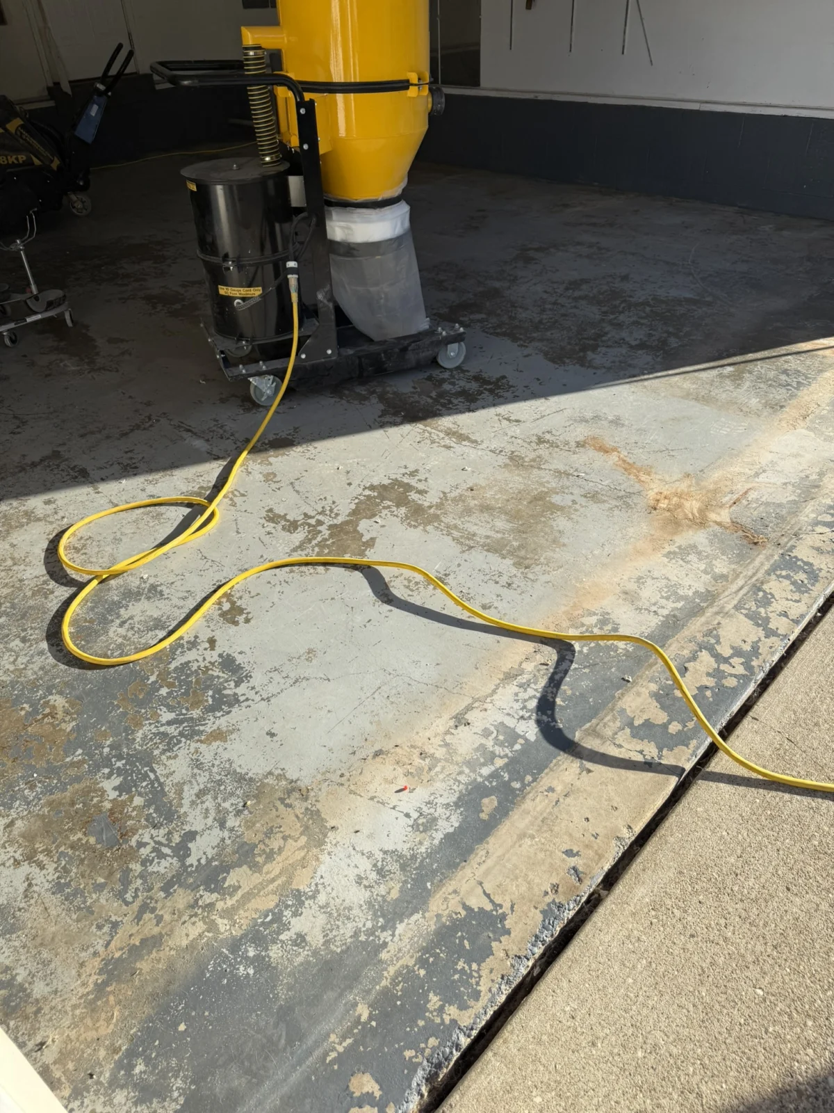 Peeling coating and exposed concrete near the Charleston garage entrance before replacement.