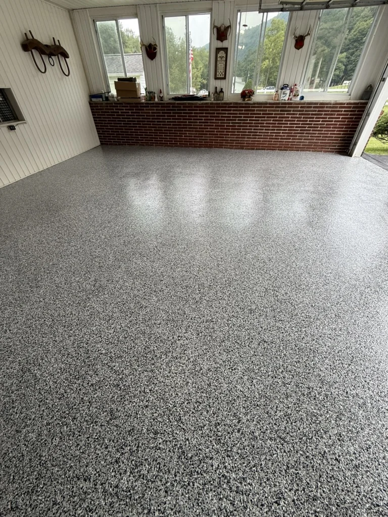 Finished floor — Domino decorative flake coating across the garage toward the window wall in Wytheville.