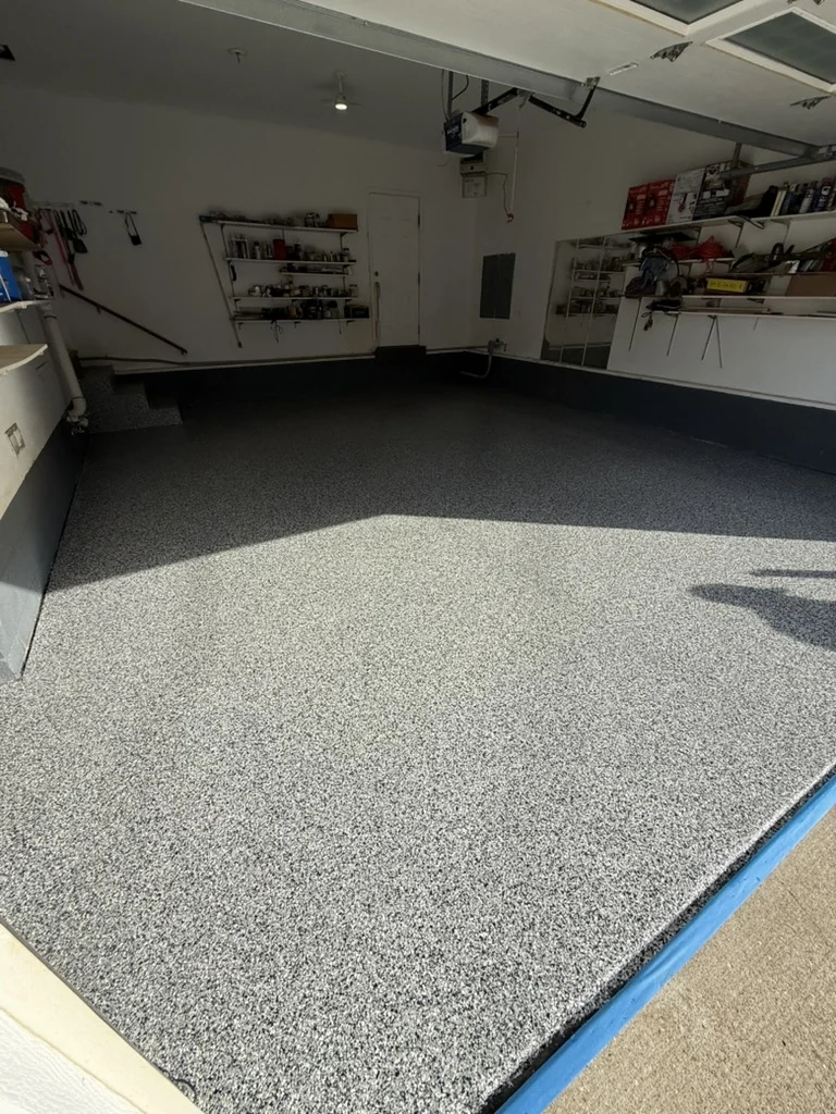 Completed decorative flake garage floor viewed from the entrance in Charleston, WV.