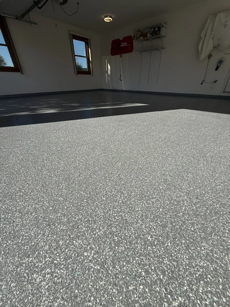Finished gray-and-white garage coating viewed toward the rear wall