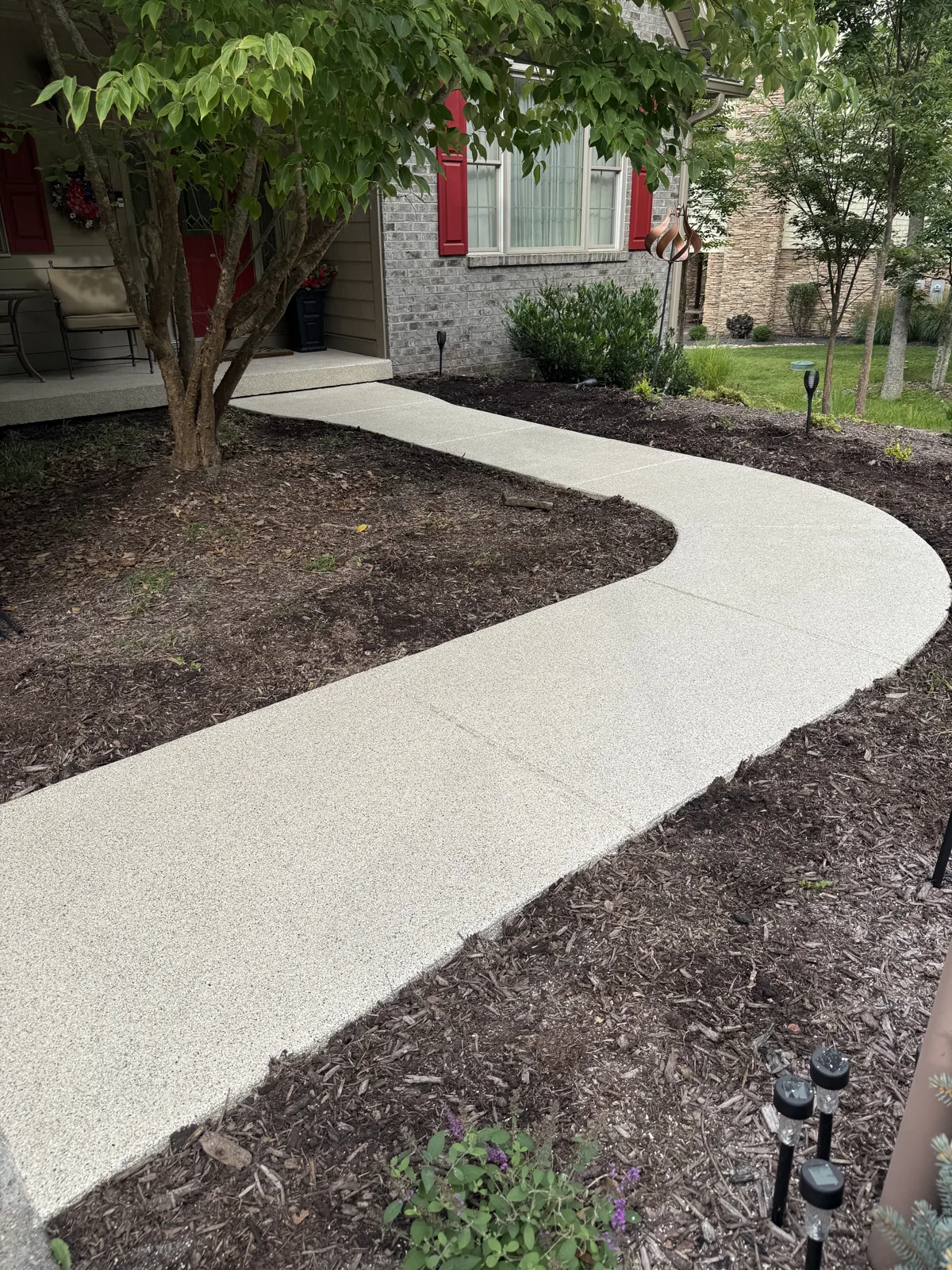 Side view of the curved decorative-flake walkway and matching porch in Glade Springs, Daniels, West Virginia