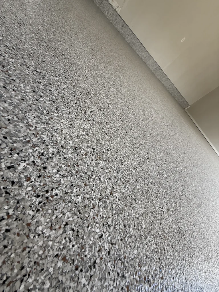 Close-up of gray decorative flake garage flooring near Princeton, West Virginia